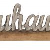 Silberner Metall-Schriftzug "Zuhause" auf Holz-Standfuß